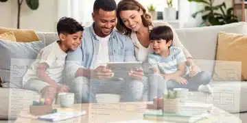 Family reviewing 2026 Child Tax Credit information on a tablet, symbolizing financial planning.